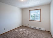 Thumbnail 12 of 25 - a bedroom with a window and carpeted floors. Fargo, ND Westview Towers Apartments