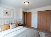Thumbnail 4 of 25 - a bedroom with a bed and a closet. Fargo, ND Westview Towers Apartments