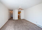 Thumbnail 7 of 25 - a spacious living room with carpet and a ceiling fan. Fargo, ND Westview Towers Apartments