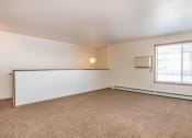 Thumbnail 4 of 15 - an living room with a window and a white wall. Fargo, ND Foxtail Townhomes