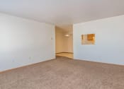 Thumbnail 5 of 15 - an empty living room with white walls and carpet. Fargo, ND Foxtail Townhomes