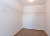 Thumbnail 10 of 15 - a closet with a white wall and a wire rack on the wall. Fargo, ND Foxtail Townhomes