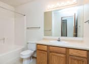 Thumbnail 13 of 15 - a bathroom with a sink toilet and a mirror. Fargo, ND Foxtail Townhomes
