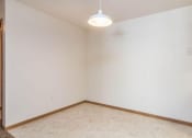 Thumbnail 8 of 15 - an empty living room with white walls and a ceiling lamp. Fargo, ND Foxtail Townhomes