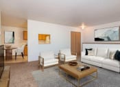 Thumbnail 1 of 15 - a living room with a couch and a coffee table. Fargo, ND Foxtail Creek Townhomes