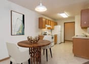 Thumbnail 2 of 15 - a kitchen and dining room with a table and chairs. Fargo, ND Foxtail Creek Townhomes