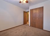 Thumbnail 12 of 25 - a bedroom with a closet and a door to a hallway. at France, North Dakota