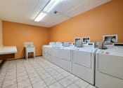 Thumbnail 24 of 25 - a row of washers and dryers in a laundry room at France, Fargo North Dakota