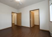 Thumbnail 14 of 23 - a bedroom with wood floors and a closet. Fargo, ND North Sky Apartments