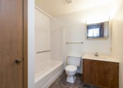 Thumbnail 7 of 7 - Mandan, ND Garden Grove Apartments. A bathroom with a toilet sink and bathtub