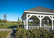 Thumbnail 30 of 31 - A gazebo surrounded by greenery. Fargo, ND Stonebridge Apartments