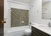 Thumbnail 12 of 32 - Fridley, MN Georgetown Apartments. A bathroom with a sink toilet and bathtub
