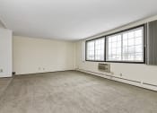 Thumbnail 14 of 32 - the living room of an empty house with a large window. Fridley, MN Georgetown on the River Apartments
