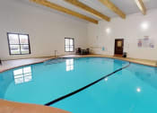 Thumbnail 28 of 32 - the indoor pool is spacious and has a ceiling with exposed beams