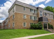 Thumbnail 32 of 32 - a brick apartment building with a solar roof on top of it. Fridley, MN Georgetown on the River Apartments