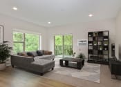 Thumbnail 2 of 29 - a living room with a couch coffee table and bookshelf