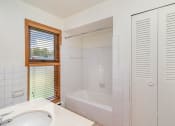Thumbnail 9 of 19 - a bathroom with a tub and a sink and a window.  Golden Valley, MN Valley View Apartments