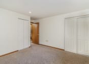 Thumbnail 7 of 19 - a bedroom with two closets and a door to a hallway.  Golden Valley, MN Valley View Apartments