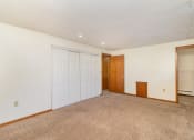 Thumbnail 14 of 19 - a bedroom with a large closet and door to a hallway.  Golden Valley, MN Valley View Apartments