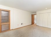 Thumbnail 15 of 19 - a large room with white walls and a door to a closet.  Golden Valley, MN Valley View Apartments