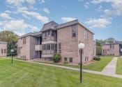 Thumbnail 17 of 19 - a brick apartment building with a green lawn and sidewalk.  Golden Valley, MN Valley View Apartments
