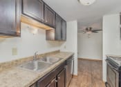 Thumbnail 12 of 19 - an empty kitchen with a sink and a ceiling fan.  Golden Valley, MN Valley View Apartments
