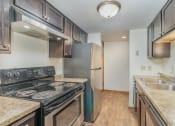 Thumbnail 11 of 19 - an empty kitchen with stainless steel appliances and granite counter tops.  Golden Valley, MN Valley View Apartments