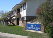 Thumbnail 9 of 10 - The exterior of a two level apartment building at Highland Meadows in Bismarck, ND