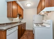 Thumbnail 4 of 11 - White Bear Lake, MN White Bear Terrace Apartments.  a kitchen with white appliances and wooden cabinets