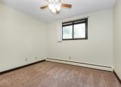 Thumbnail 7 of 11 - White Bear Lake, MN White Bear Terrace Apartments.  a bedroom with a ceiling fan and a window