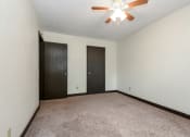 Thumbnail 8 of 11 - White Bear Lake, MN White Bear Terrace Apartments.  an empty room with a ceiling fan and two doors
