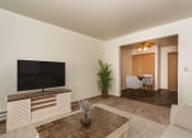 Thumbnail 2 of 11 - a living room with a tv and a dining room in the background  at Amberwood Court, Grand Forks, ND, 58201