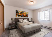 Thumbnail 6 of 16 - Grand Forks, ND Autumn Ridge. A bedroom with a bed and two nightstands with a window.