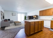Thumbnail 5 of 16 - Grand Forks, ND Autumn Ridge. a kitchen and living room with a couch and coffee table