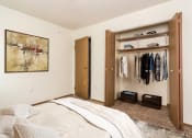 Thumbnail 6 of 19 - Grand Forks, ND Bristol Park Apartments. a bedroom with a closet and a painting on the wall
