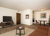 Thumbnail 4 of 19 - Grand Forks, ND Bristol Park Apartments. a living room with a couch a table and a television