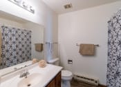 Thumbnail 14 of 14 - a bathroom with a sink and a toilet and a shower. Grand Forks, ND Cedarwood Apartments