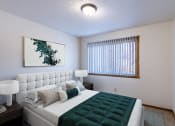 Thumbnail 5 of 14 - a bedroom with a large bed and a window. Grand Forks, ND Cedarwood Apartments