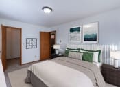 Thumbnail 4 of 14 - a bedroom with a bed and two lamps and a door to a bathroom. Grand Forks, ND Cedarwood Apartments