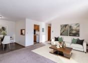 Thumbnail 3 of 14 - a living room and dining room with a couch and a table. Grand Forks, ND Cedarwood Apartments