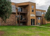 Thumbnail 1 of 14 - Grand Forks, ND Cedarwood Apartments. The exterior of a three level apartments building