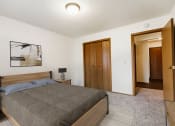 Thumbnail 4 of 11 - Grand Forks, Chandler 1802 Apartments. a bedroom with a bed and a door to a bathroom