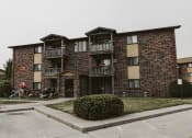 Thumbnail 2 of 2 - Grand Forks, ND Chandler 1834 Apartments. A photo of a brick apartment building with balconies