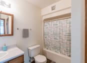 Thumbnail 11 of 19 - a bathroom with a shower and a toilet and a sink. Grand Forks, ND Chandler 1866 Apartments