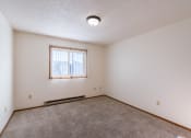 Thumbnail 10 of 19 - a bedroom with carpet and a window. Grand Forks, ND Chandler 1866 Apartments