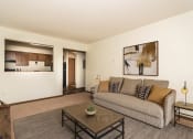 Thumbnail 5 of 7 - a living room with a couch and a coffee table. Grand Forks, ND Chandler 1898 Apartments