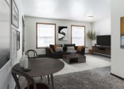 Thumbnail 1 of 8 - Grand Forks, ND Claremont Apartments. a living room with white walls and grey carpet with two windows. A black couch, 2 chair dining table, coffee table and tv fill the room