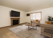 Thumbnail 5 of 10 - Grand Forks, ND Columbia West Apartments a living room with a fireplace and a tv