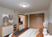Thumbnail 5 of 17 - A bedroom with a bed and a closet. Grand Forks, ND Creekside Apartments.