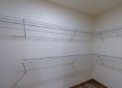 Thumbnail 17 of 19 - Grand Forks, ND Grandview Apartments. A closet with two rows of shelves.